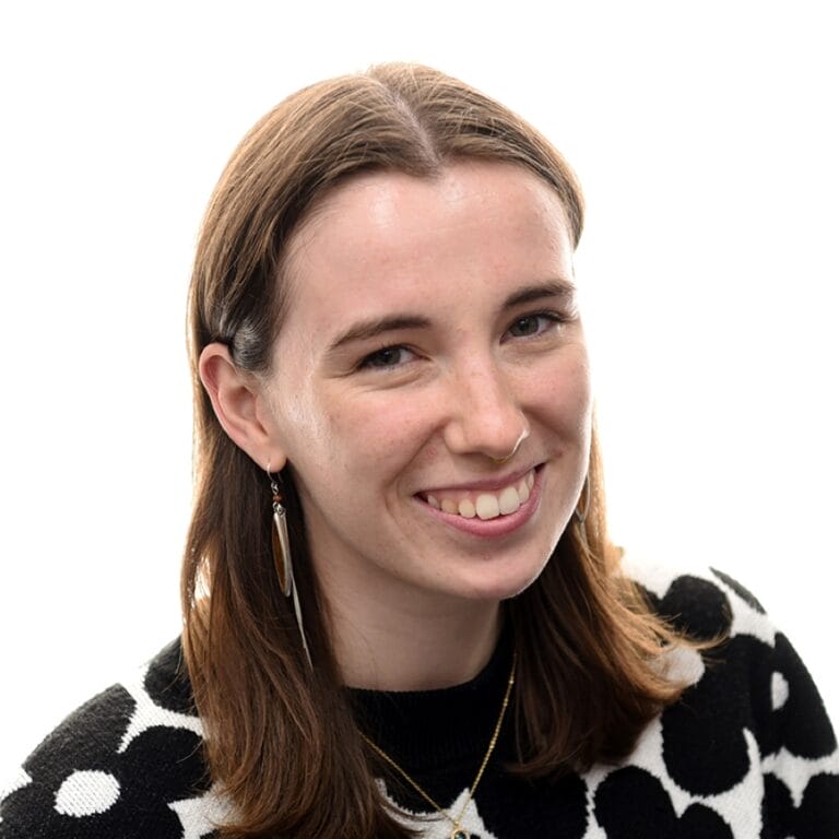 Image of Caroline smiling at the camera on a white background.