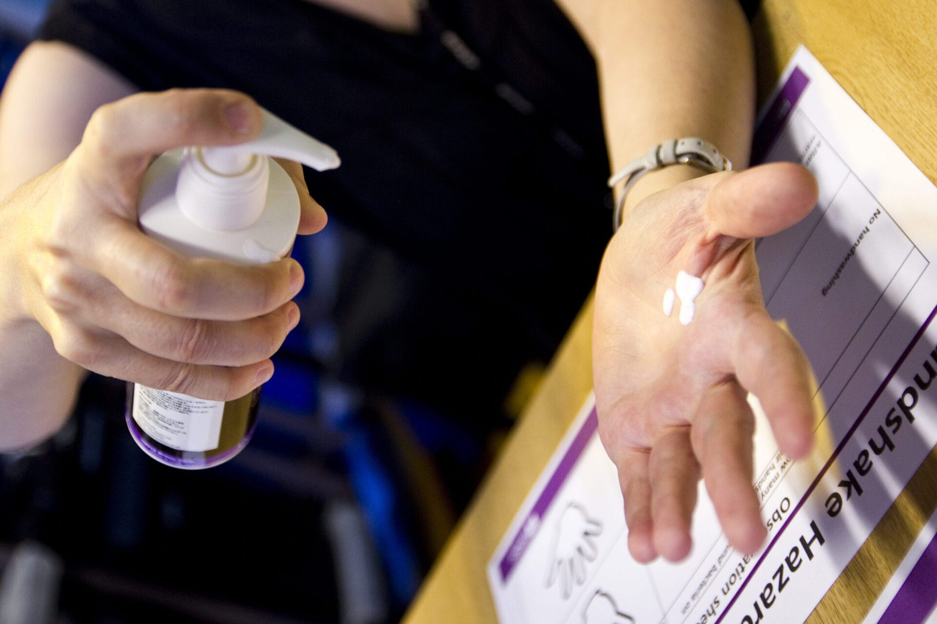 Image of hand held out with soap being sprayed onto it.